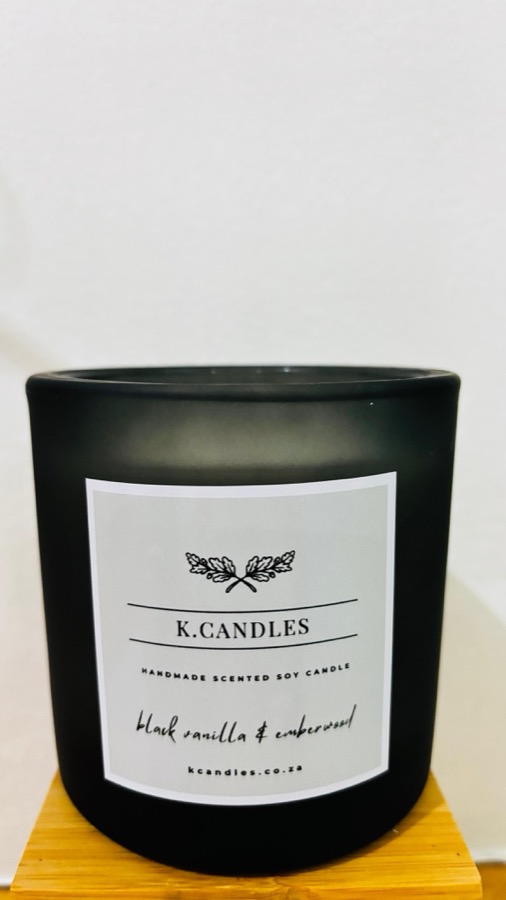 Large K.Candles soy candle in a frosted black glass jar